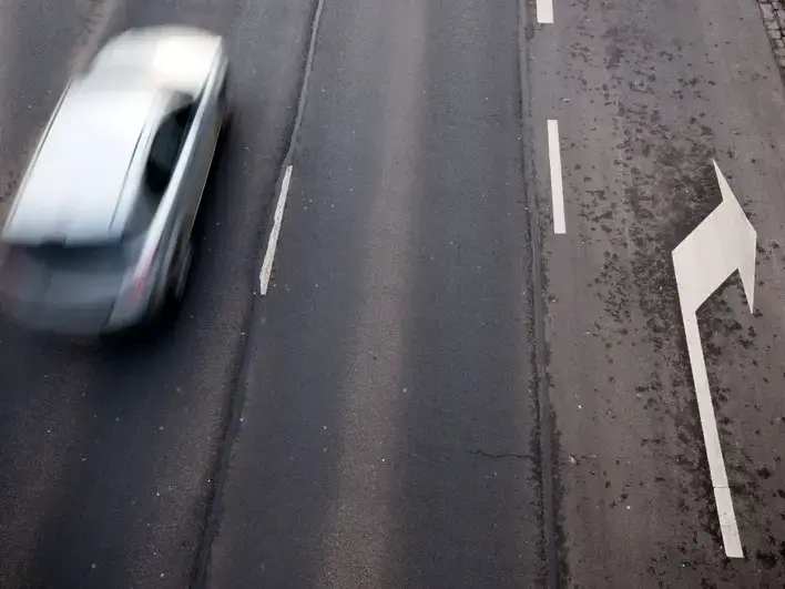 Insurance negotiation for Ahwatukee left turn injury claim with attorney examining Arizona traffic report and settlement documents